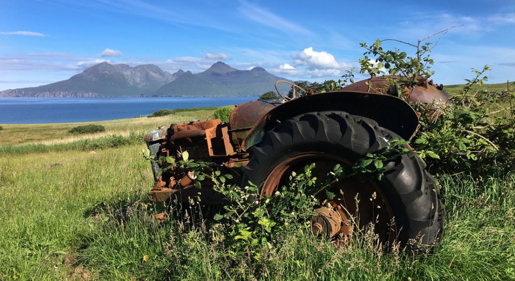 Old tractor on the Isle of Eigg with Rum in the distance