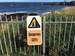 Sign for dangerous cliffs on the John Muir Way at Dunbar